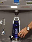 water bottle sets down and water automatically fills reusable bottle from the top